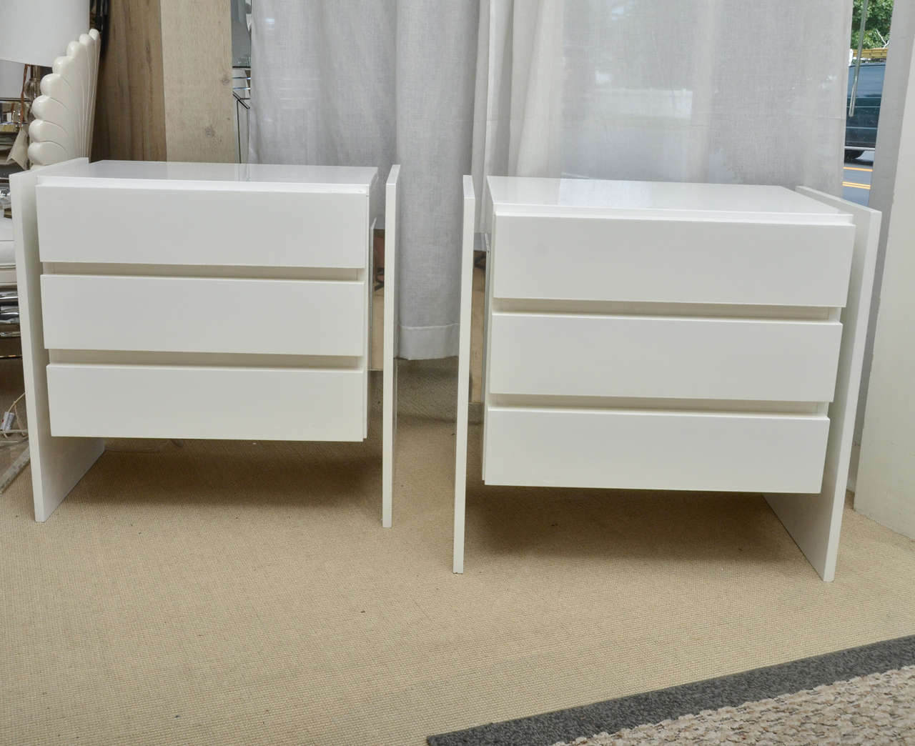 Very chic pair of vintage three-drawer white lacquer nightstands with chrome trim.