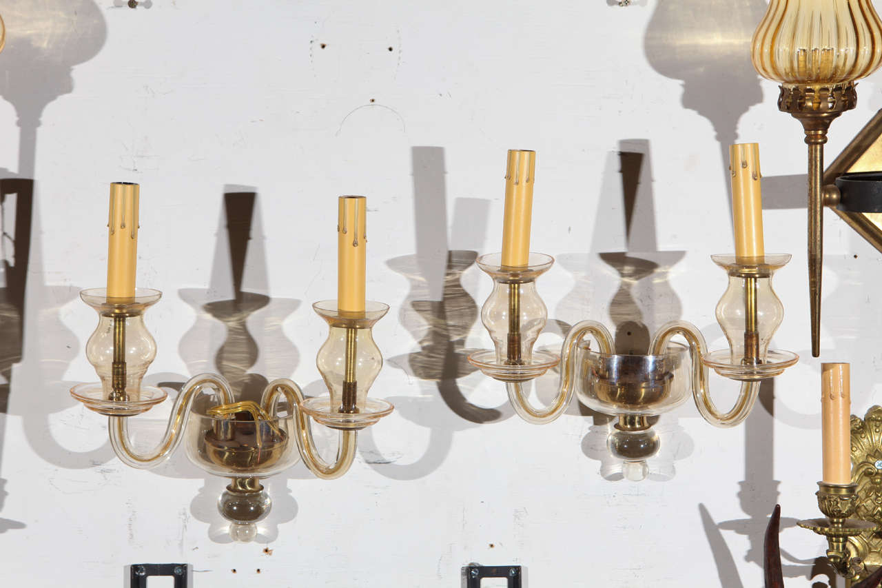 This pair of champagne or taupe colored handblown Murano glass and brass sconces are a fine example of the timeless quality of Italian glasswork and will add elegance and interest in a variety of design settings. These have been recently re-wired