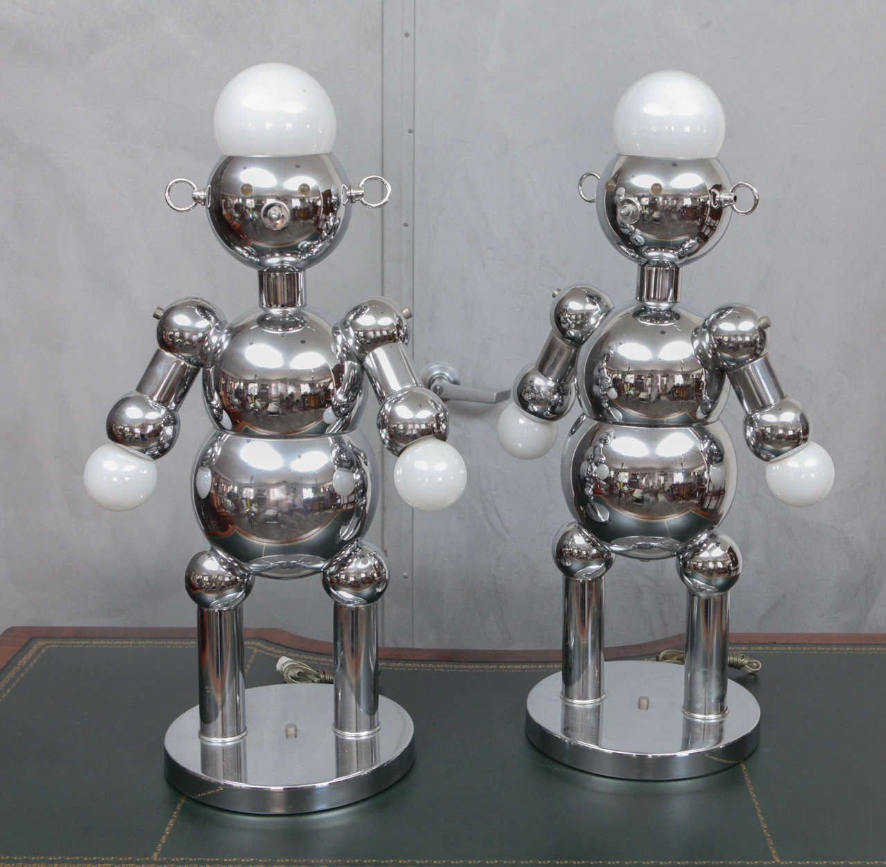 This is a fantastic, whimsical pair of Italian Figural Chrome Robot Table Lamps by Torino Lamp Co. made in the 1970's as a part of a series of multiple characters and scales of robot lamps. These two are larger than alot of the pieces found. This