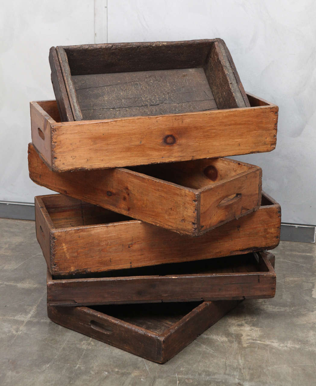 These wonderful rustic American Industrial Factory Trays are in a few different sizes and can be sold singly or in groups. Besides the smallest tray, these trays have nice cutout handles that make them utilitarian as trays and can be used as great