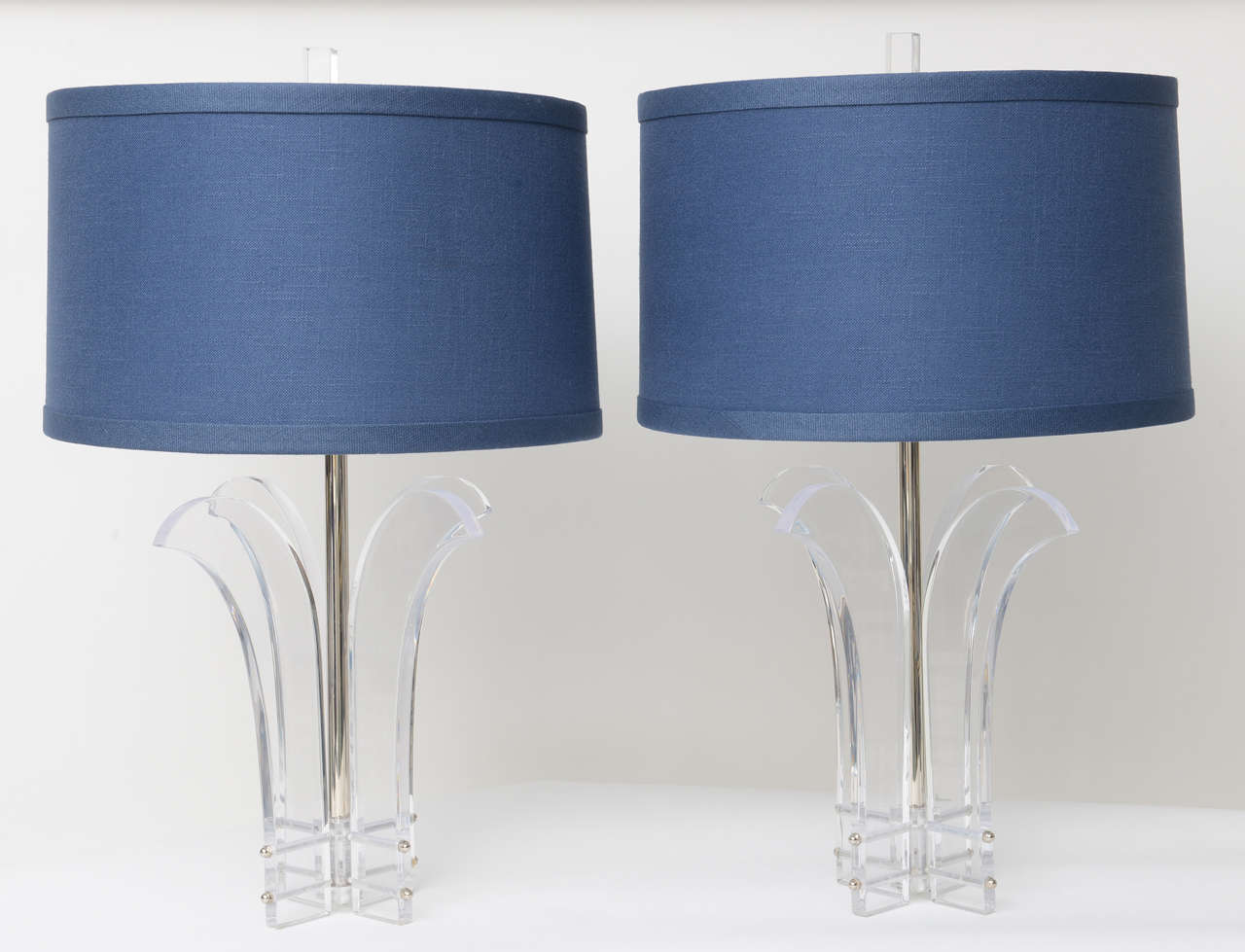 Pair of Lucite lamps featuring four plume-like arms. Newly rewired and appointed with nickel fittings including the screw covers, centre post, and sockets.