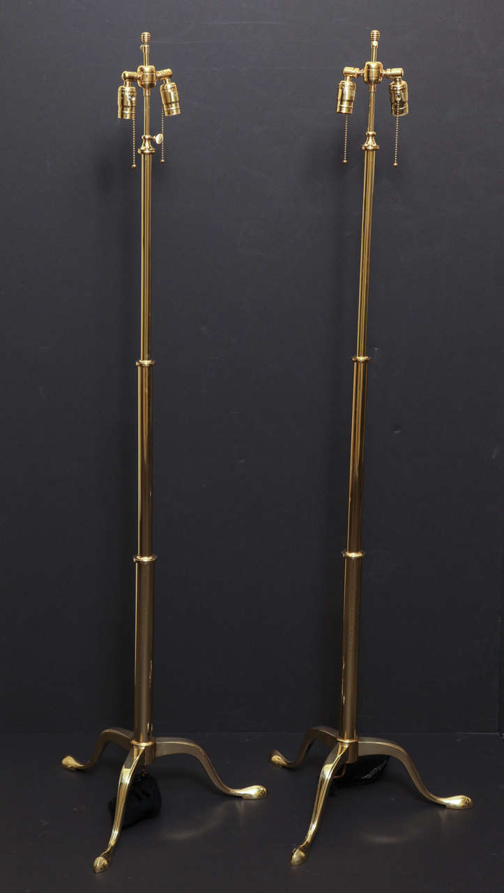 Pair of Two Light Polished Brass Telescoping Floor Lamps Supported By Tripod Cabriole Legs.