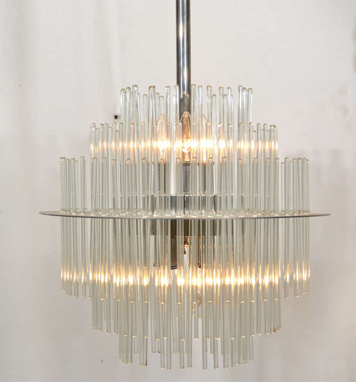 1960's modern, Polished Nickle Plated Steel and Brass fixture featuring pencil glass rods in varying lengths, illuminated top and bottom with seven candelabra 60 watt bulbs.  Three fixtures are available.