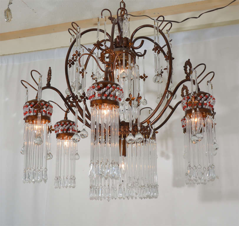 Dramatic crystal chandelier, bronze finish, with lovely crystal and red faceted beads to accentuate the oriental design.
