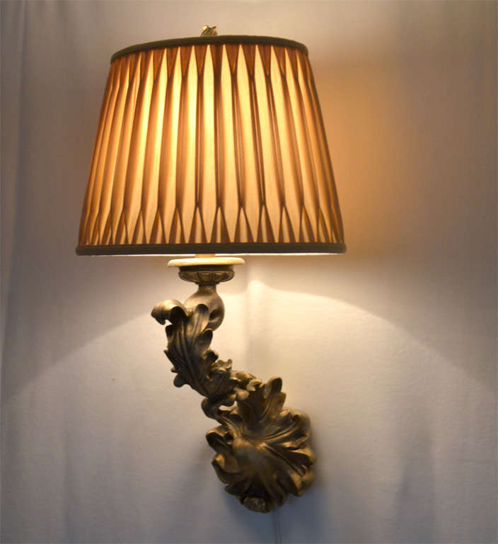 Molded plaster wall sconces, made by the Sirmos Company, finished in antique gold, original finish. Shown with 14