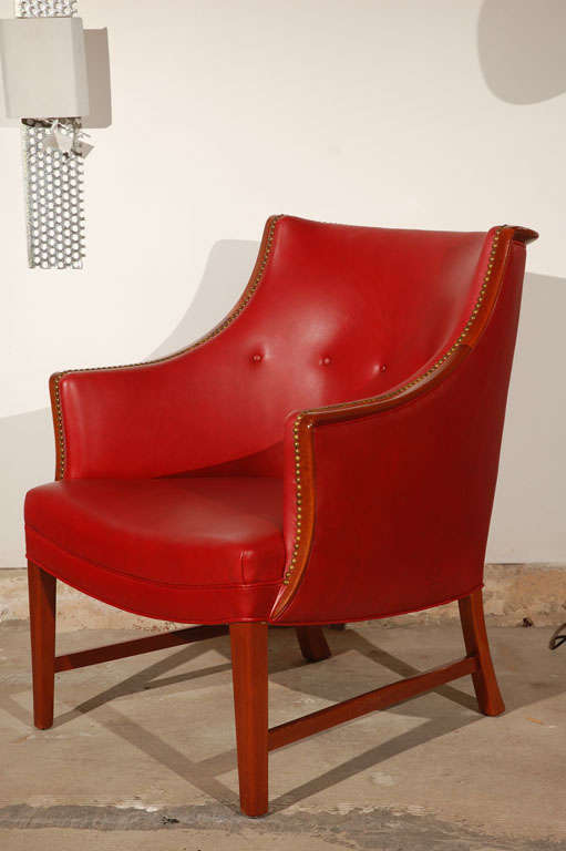 Frits Henningsen leather, mahogany and brass lounge chair with nailheads from Denmark, circa 1940.