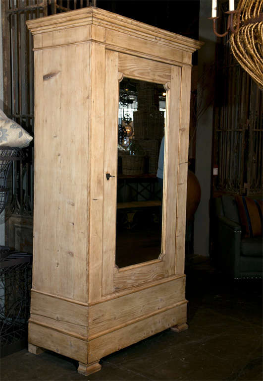 French pine bonnetiere, c. 1880, of the Louis Philippe style, a mirrored door panel and the interior now fitted with a zinc lined bar