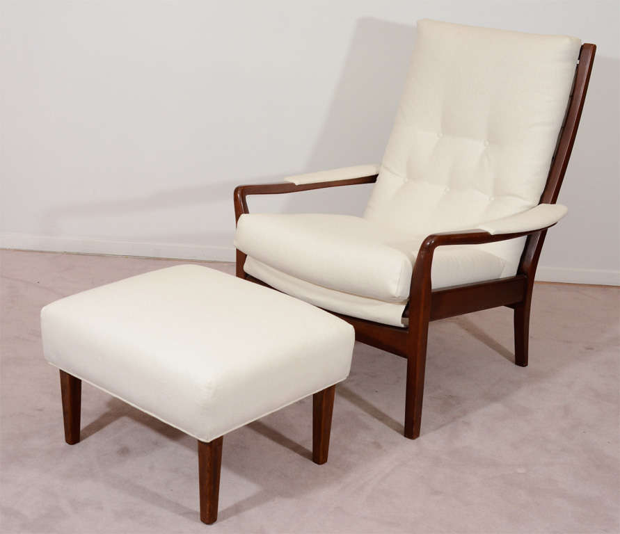 A vintage Danish Modern style armchair with matching ottoman. Each has a deep walnut frame and has been recently re-upholstered in ivory-white.

Price Reduced from : 3200.00

Dimensions:
Chair -
H: 36