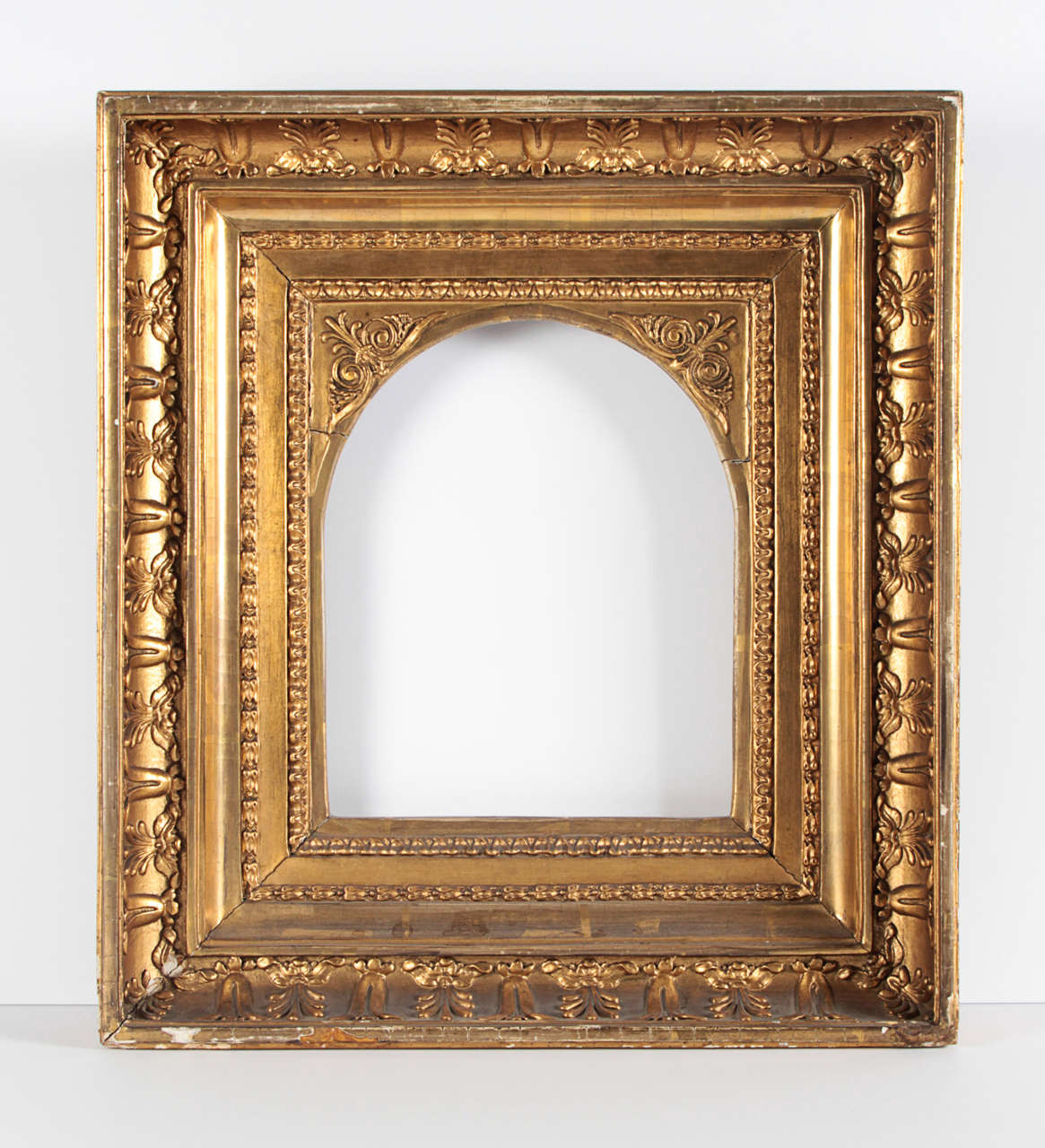 European composition frame with Greek Revival Anthemion decoration with arched opening, lap joint construction

Overall dimensions: 16 1/4 x 14 5/8 inches
Rabbet dimensions: 9 1/4 x 7 5/8 inches
Moulding width: 3 3/4 inches