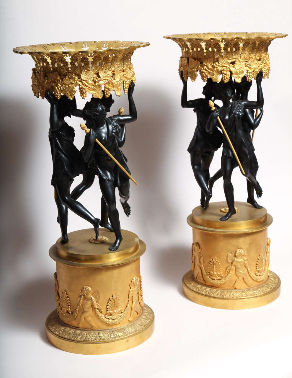 Pair of French neoclassical patinated and gilt bronze figural centerpieces In Good Condition In New York, NY