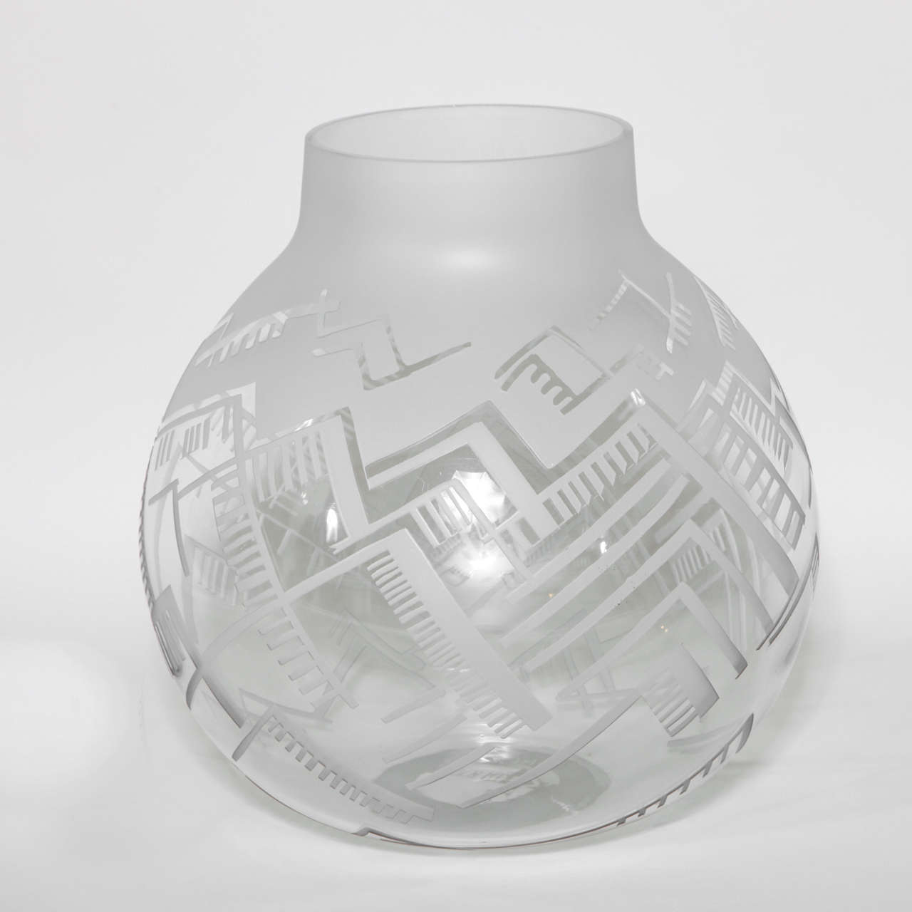 Spherical vase with geometric pattern in frosted and etched glass.
Signed: LACROIX/ 1927 with molded mark.

Boris-Jean Lacroix had a prolific career designing wallpaper, furniture and interiors, and most notably for his Modernist lighting.