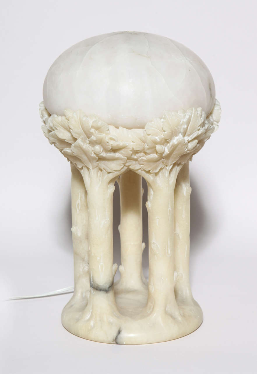 Alabaster lamp carved as five tree trunks surmounted by clusters of oak leaves and acorns. 
Rewired for US standards. 
Numbered: 2004.