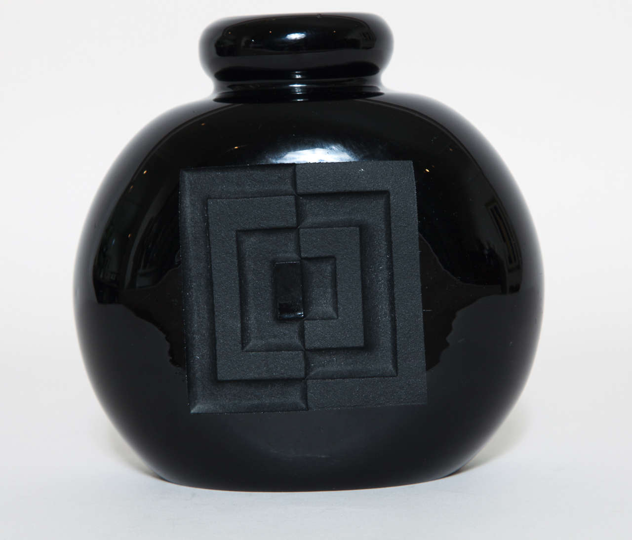 Black glass vase with deeply etched geometric design on front and back by Jean Luce (1895-1964).
Signed: artist's monogram

Jean Luce worked as a designer in a cubist-inspired style, rejecting the use of too much design and figurativeness in