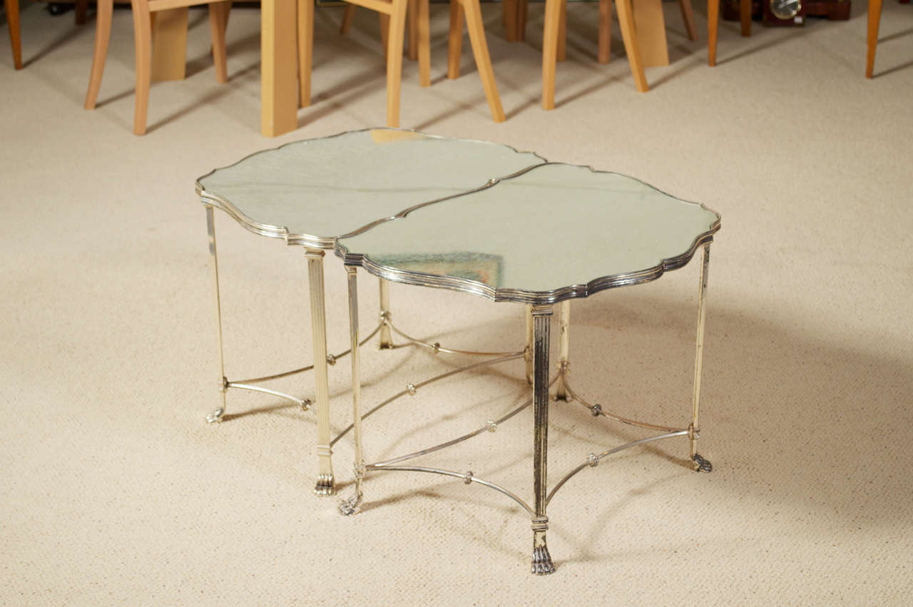 For your consideration is this 1950's pair of silver plated, French plateau, paw footed, neo classical side tables that puzzle piece together to make cocktail table.  The top features antiqued mirrored glass. 

Measurements are for both tables