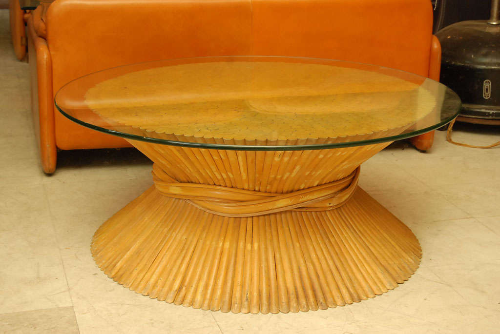 Large rattan coffee table with plate glass top in wheat-sheaf pattern by Maguire.