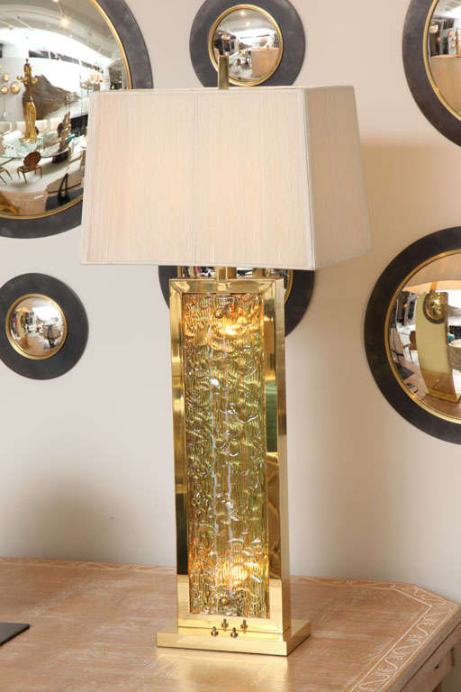 Massive pair of polished brass and Murano glass table lamps.  Vintage silk string shades included.  Double socket and newly rewired.  Lights on interior of glass and at sockets.

THIS ITEM IS NOW LOCATED IN OUR MANHATTAN SHOWROOM:  
200 LEXINGTON