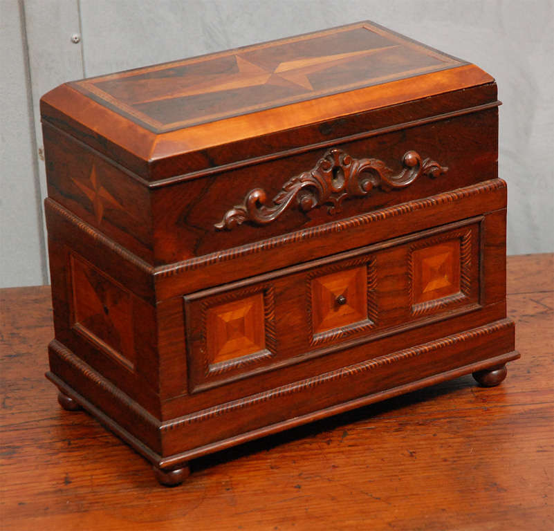 This is a good example of times gone by when a gentleman had time to dress in a more leisurely pace. This keepsake holder will be a pleasing reminder of those times and show a certain affluence and attitude. The box is made of Walnut and various