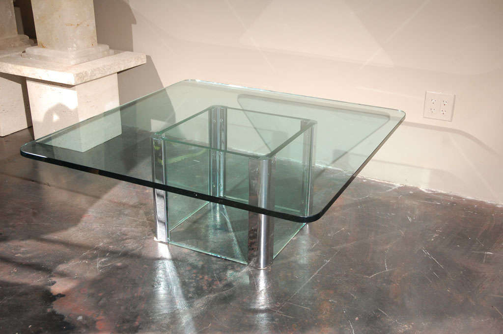 A chrome and glass coffee table by Pace International. Chrome corner mounts holding thick pieces of glass on each side. Base only without glass top measure 17 1/2