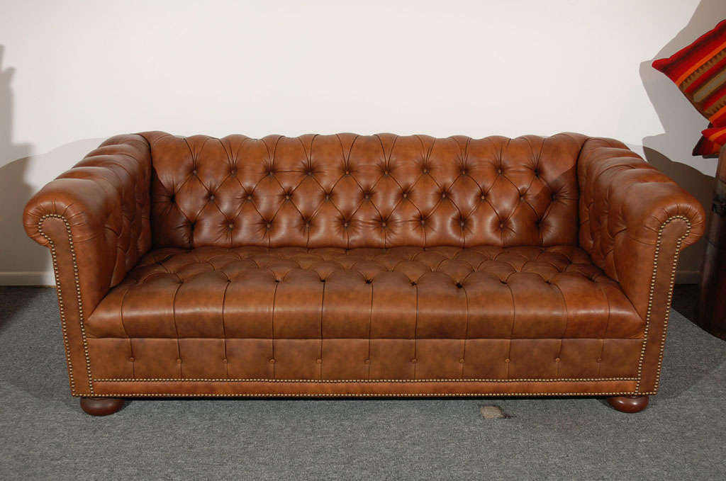 THE CHESTERFIELD SOFA IS IN A BROWN DISTRESSED PATTERN LEATHER.IT IS IN GREAT CONDITION AND HAS THE ORIGINAL BUNN FEET.IT HAS ALL THE ORIGINAL BRASS TACKS.