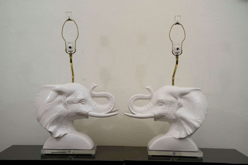 A majestic pair of Italian ceramic elephant busts that have been mounted on acrylic<br />
bases and wired as lamps....Funky and fabulous!