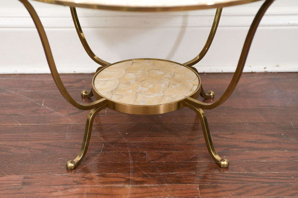A glamorous and stylish French Moderne style coffee table with a layered capiz shell<br />
surface.
