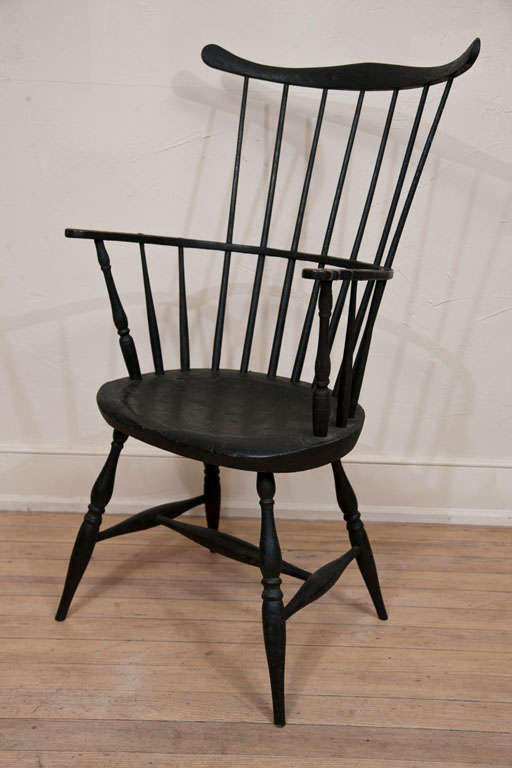 A very fine and rare 18th Century Rhode Island Comb-back Windsor Armchair with a graceful and shapely elongated comb-back extending over seven spindles, plank seat and finely tapered legs. An impeccable example in outstanding condition. 
This rare