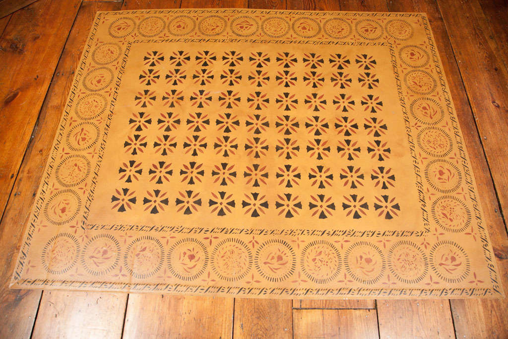 A gorgeous hand-painted floor cloth, where the design was taken from the Ebenezer Waters House in West Sutton, Mass, (center motif) and the border decoration was copied from examples at the Archibald Cox House in Windsor, Vermont.