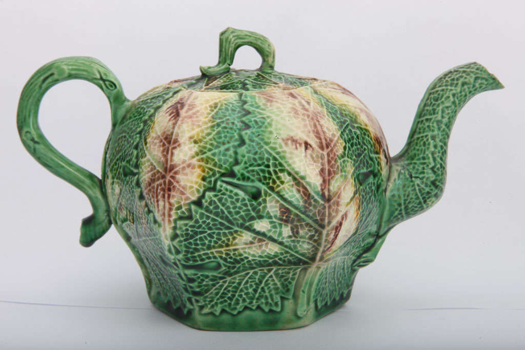 A rare Whieldon school leaf molded teapot decorated in underglaze oxide colors of yellow, green and brown