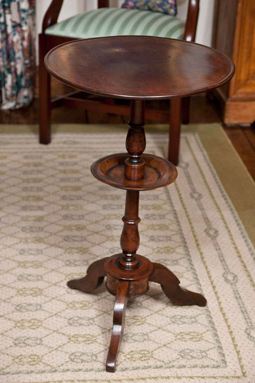 Candle stands were a requisite item prior to the 20th century and took many forms most typically that of a small, flat circular top affixed to a column and supported by a triad of cabriole legs. Oak and mahogany were the prevalent woods used to