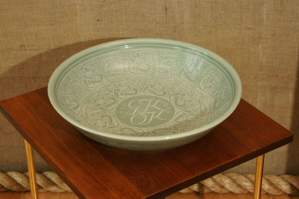 Celadon High Glazed Porcelain Dish with White Transfer Ornament of birds and floral motifs.  At the center the Initials:  GK and OK flanked by 1916 and 1966.  This dish was executed by Nils Thorsson in celebration of the Fiftieth wedding anniversary