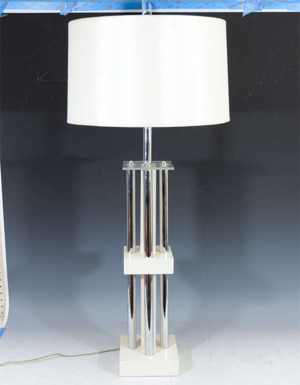A single table lamp composed of white lacquered wood blocks supporting chrome rods with lucite detailing at the top.<br />
<br />
Reduced From: $550

8130