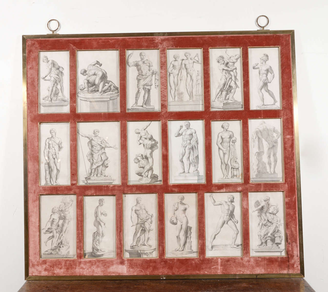 19th century lithograph sketches taken of statues from famous artists, framed under glass on red velvet wrapped brass frame. One of a kind and fabulous !