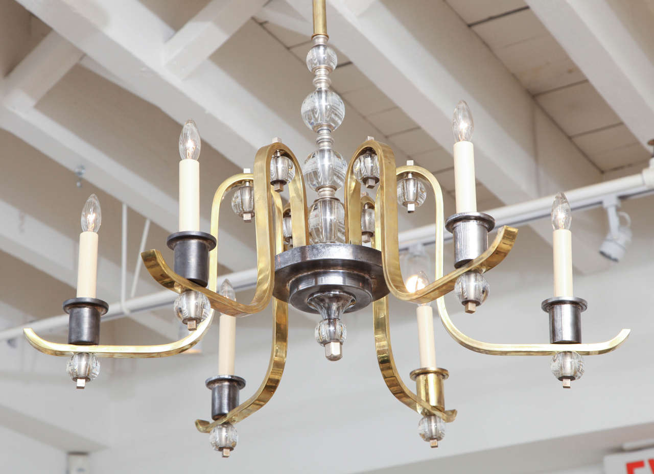 Glass, brass and steel six arm chandelier with ball details attributed to Jacques Adnet.