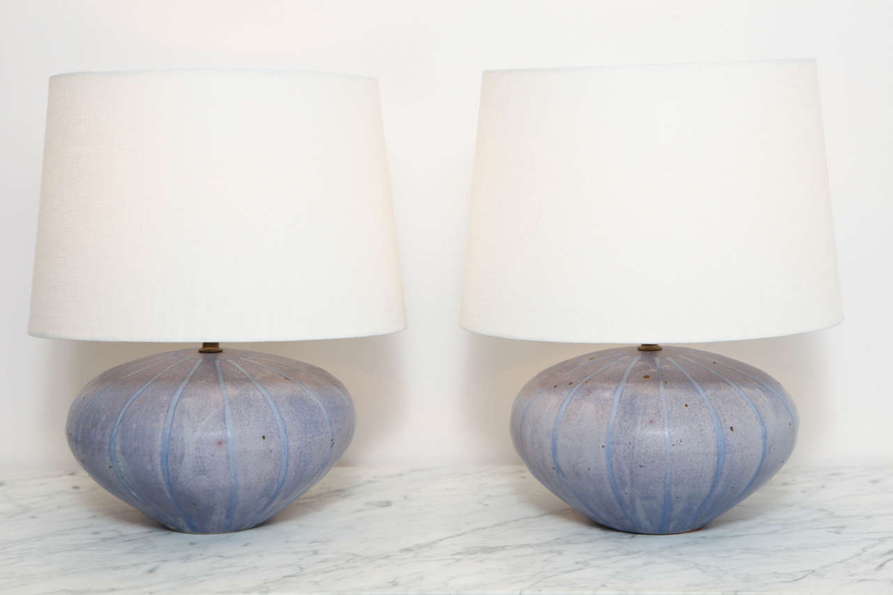 Pair of low calabaza-form stoneware table lamps with matte periwinkle glaze with iron inclusions. American, circa 1970.