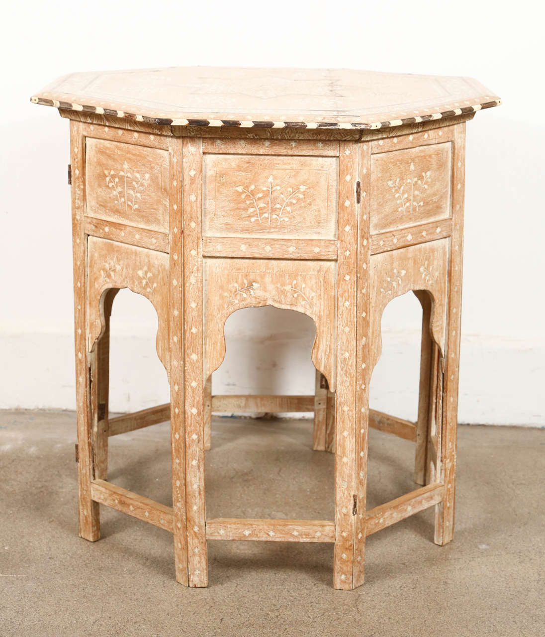 Anglo-Indian folding bone inlaid octagonal side table. Fine and elegant Anglo-Indian octagonal bleach wood table with elaborate bone and ebony inlay.The octagonal surface is finely carved and inlaid with bone and ebony floral and star designs. The