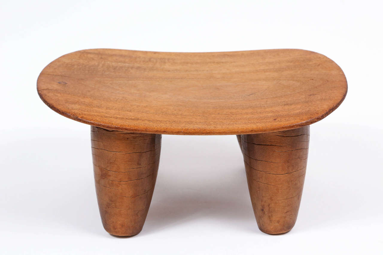 We've looked at thousands of African stools over the years, and this is without question the finest example of its kind we've come across. Masterfully carved from a single block of quarter-sawn mahogany with a wafer-thin seat, the proportions and