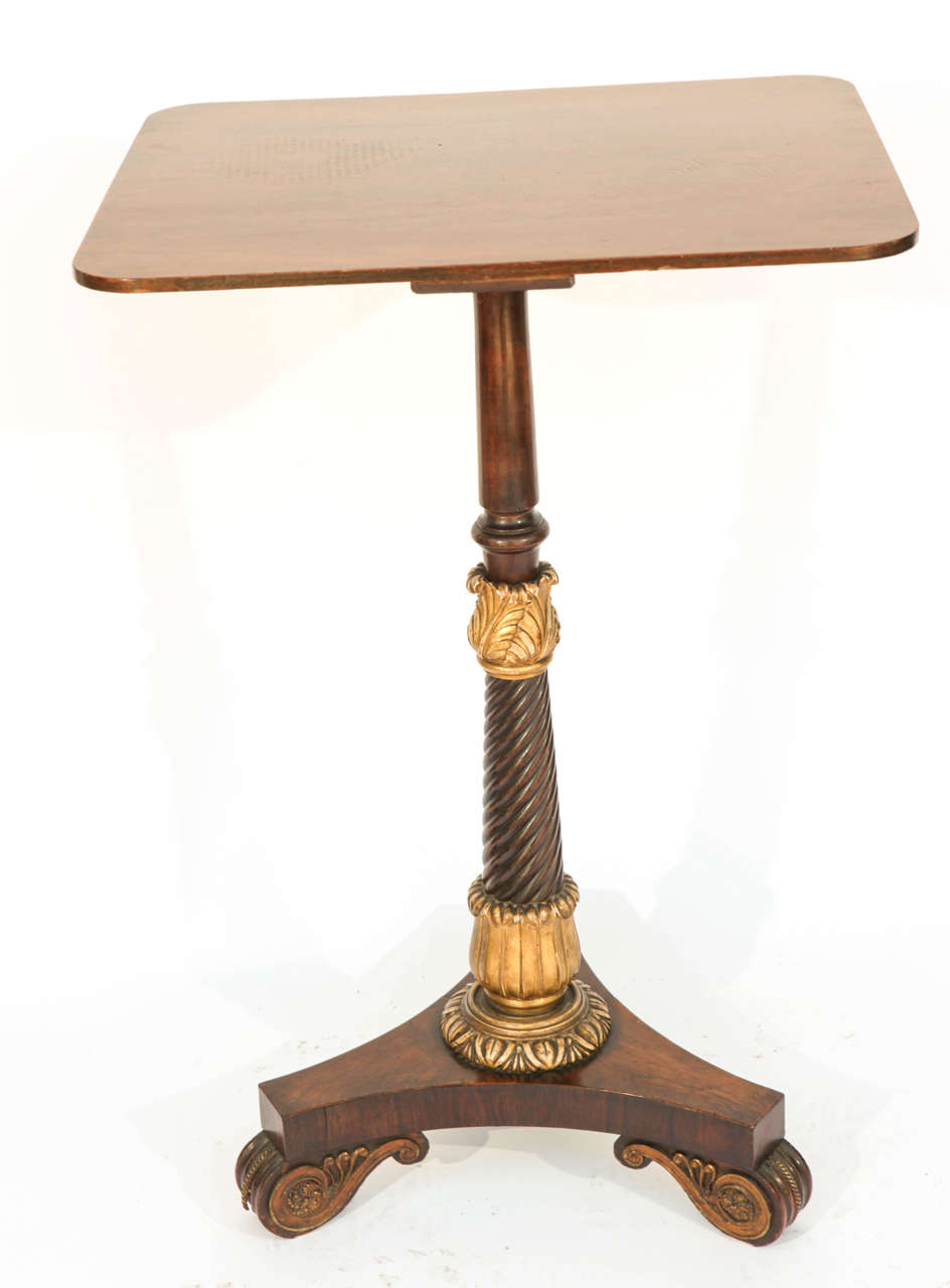 19th century English Regency tripod mahogany pedestal table with giltwood accents and bronze feet.