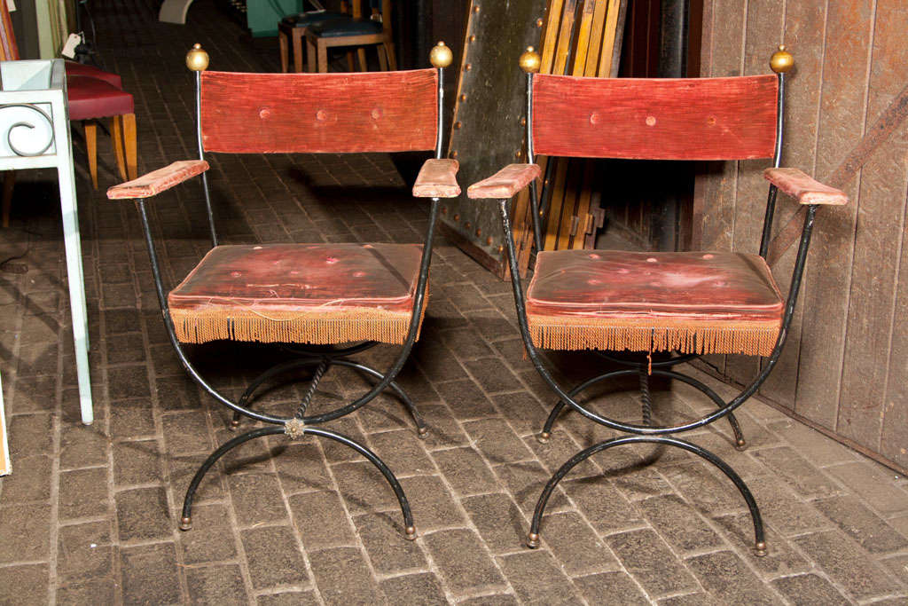 Beautiful pair of French iron arm chairs with brass ball finials.
