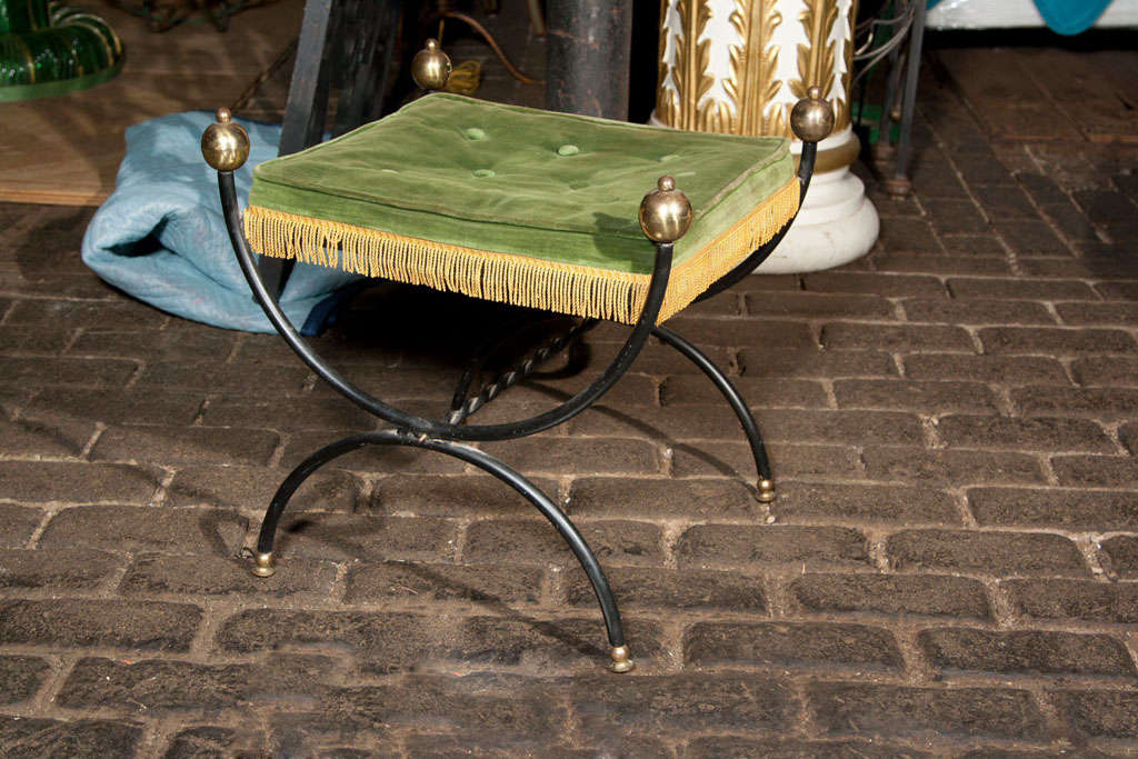 French iron bench with brass ball finials and feet.