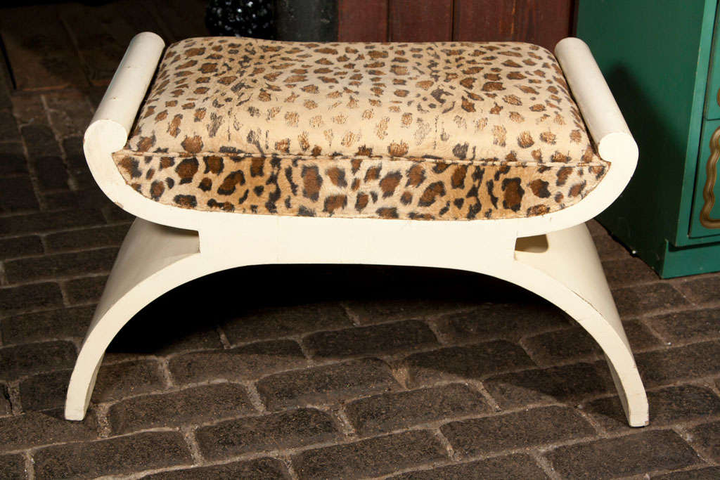 Classical lacquered wood bench with old leopard print fabric.