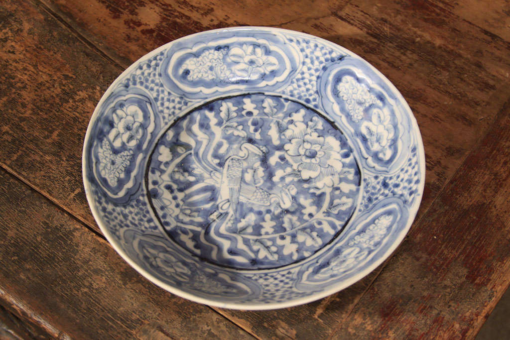Chinese blue & white porcelain bowl. Decorated in underglaze cobalt blue of a mated pair of Phoenix surrounded by blossoming tree peonies, together representing a referance to the yin and yang priciples of creation. The Phoeniz and peony are also
