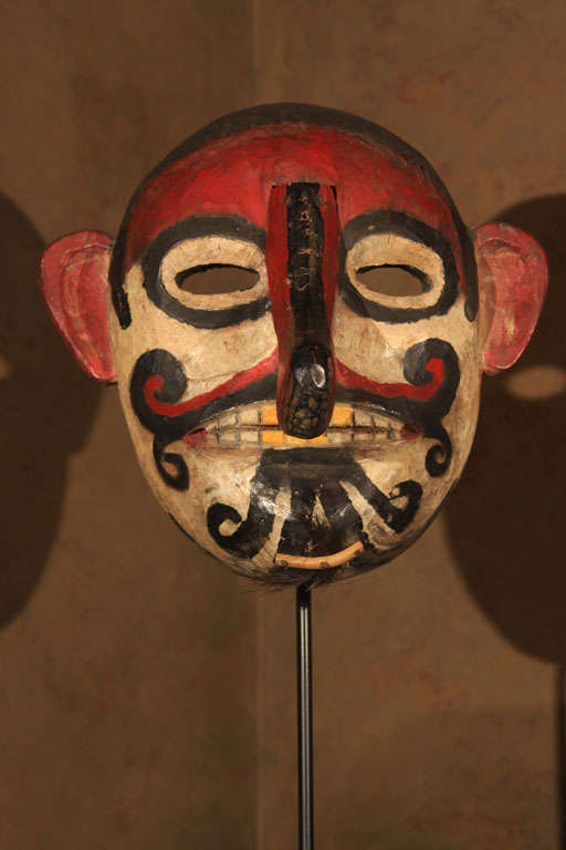 Unusual Ngaju Dayak mask from central Borneo. The carved and polychrome painted wood mask representing a brightly painted proboscis monkey with highly anthropomorphic features. Used primarily at agricultural rituals, masks such as this were also