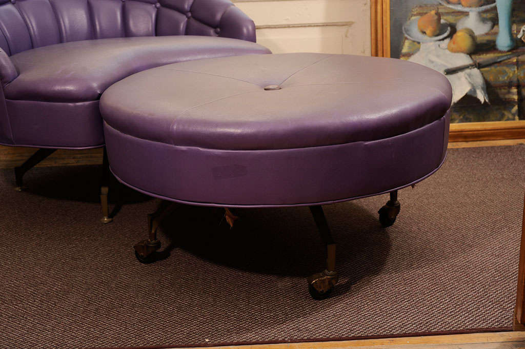 Purple leather ottoman and barrel back chair. Round ottoman on casters.<br />
<br />
Chair: 38