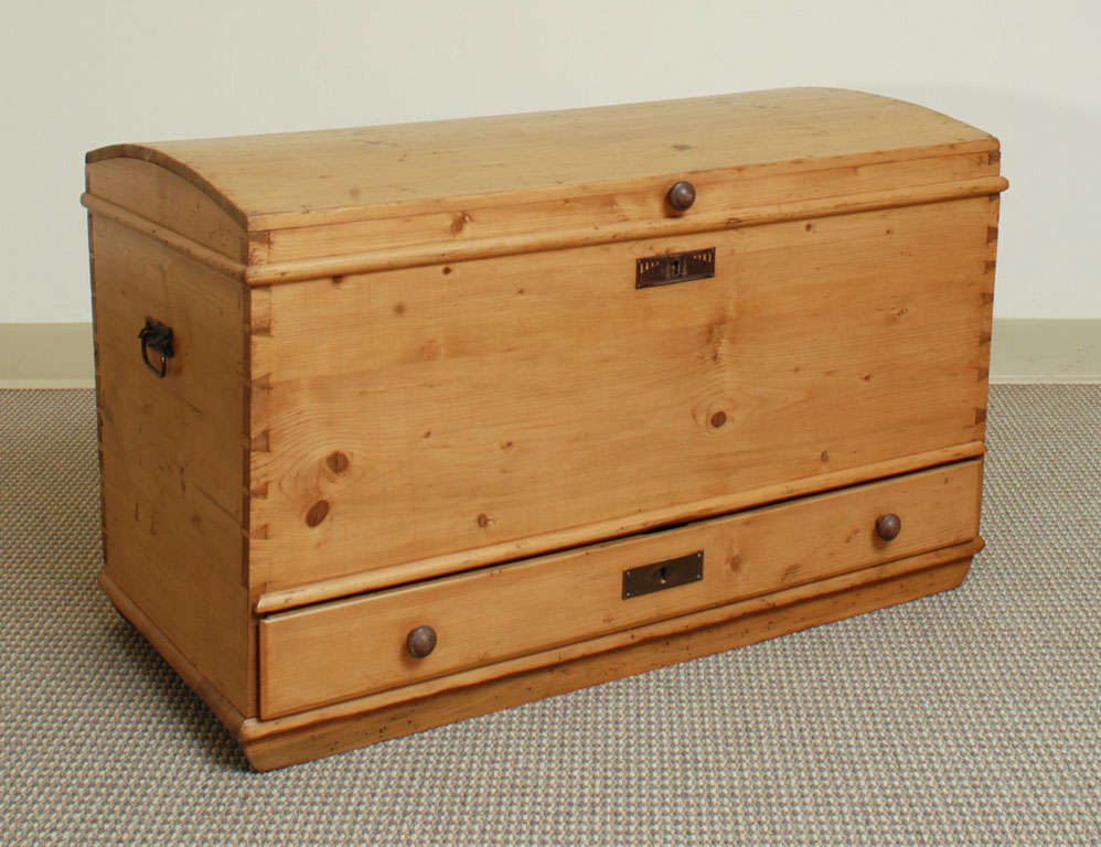 A charming and compact dome-topped mule chest featuring all-pegged and hand-cut dovetailed construction withoriginal candle box within.