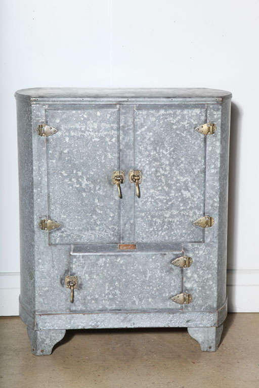 Restored zinc plate Icebox with cabrio legs, arrowhead hinges and new glass shelves.  Great for storage and display