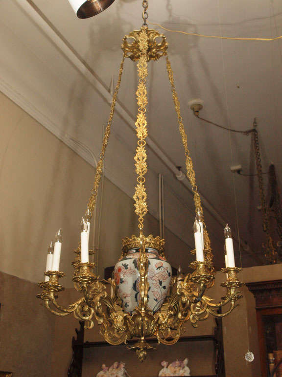 This chandelier has a very old Imari vase as its center. The pale green-blue color is most appealing, as are the floral elements in the design of the pot. The ormolu is nicely rendered and pleasing.
