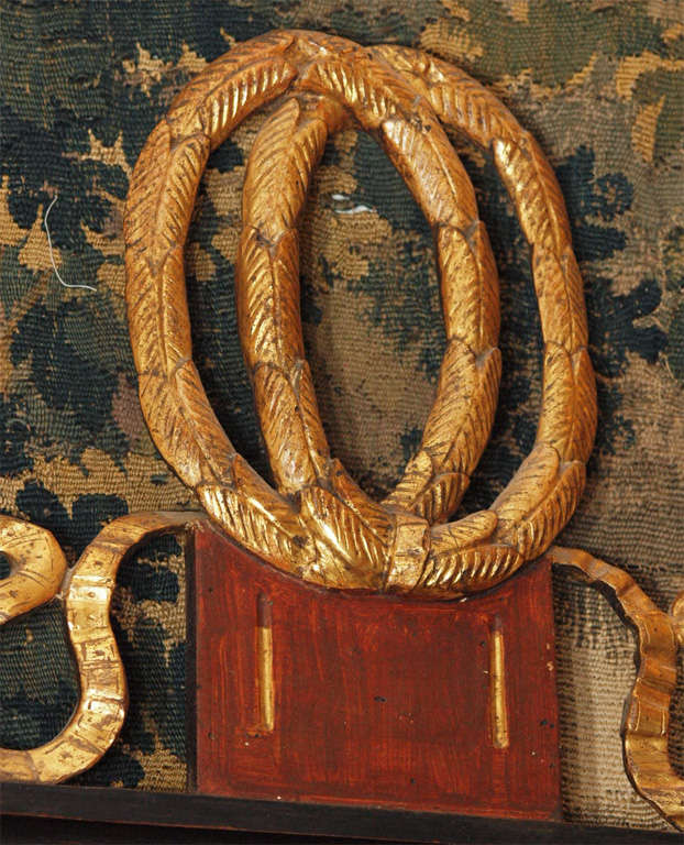 Early 19th century classical baltic faux bois and gilt mirror with eglomise panel , bow crest and paw feet