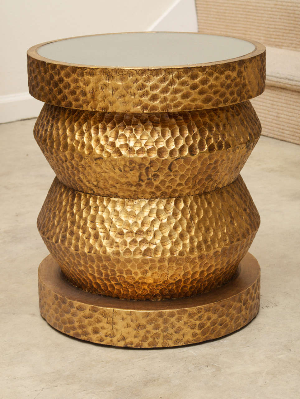 A small gold taboret with mirrored top and a 