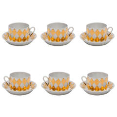A set of six Coffee Cups and Saucers by Piero Fornasetti.