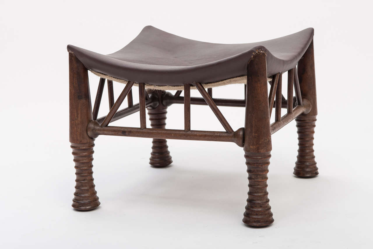 A large Mahogany Thebes Stool by Liberty and Co, London.
With leather upholstered dished seat. Raised on ring turned supports linked by stretchers.
England, circa 1900
44 cm wide x 44 cm deep x 37 cm high
